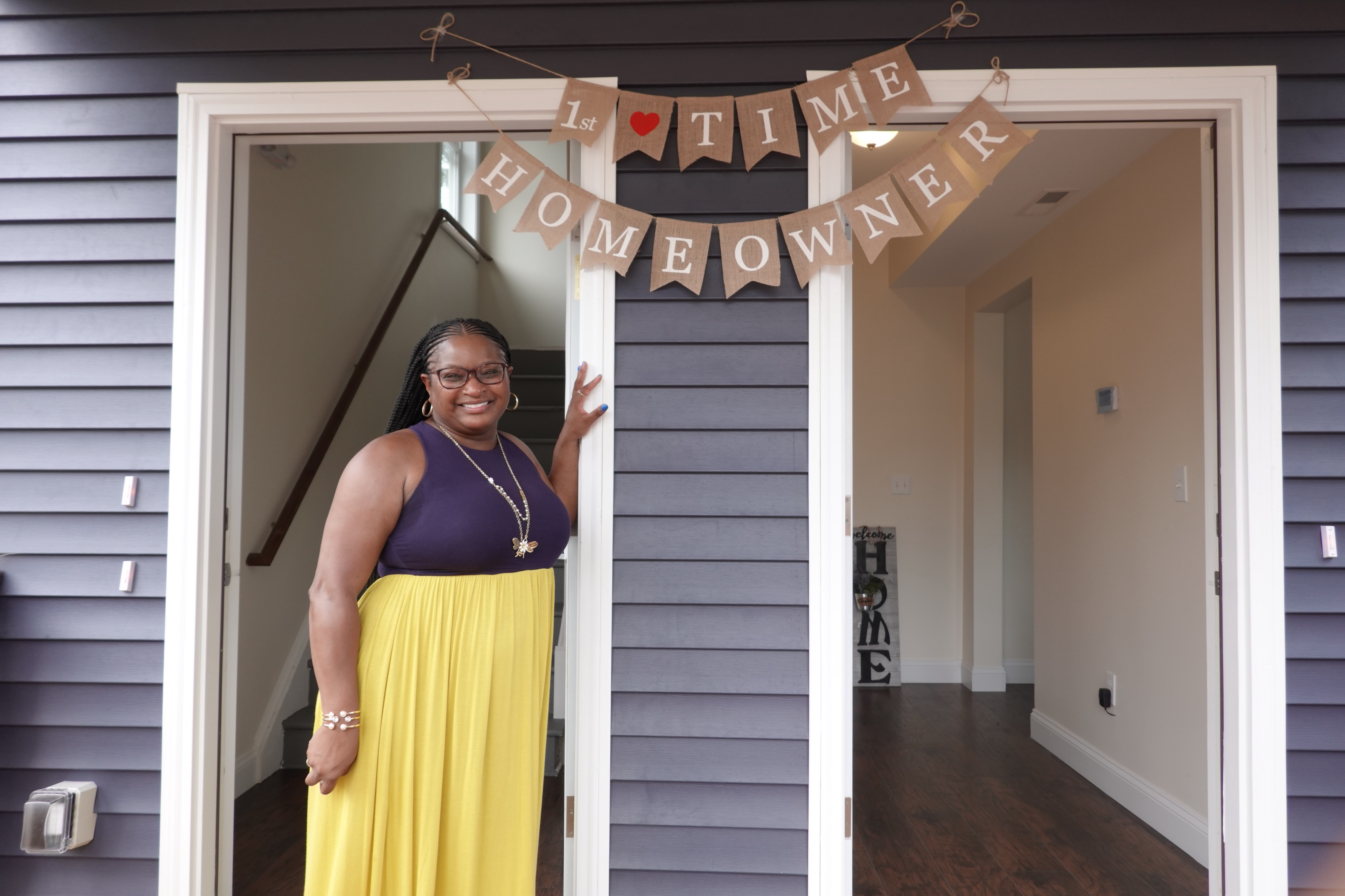 Tamika Baines at her new home renovated by NHS of New Haven and bought with The Homeownership Centers help